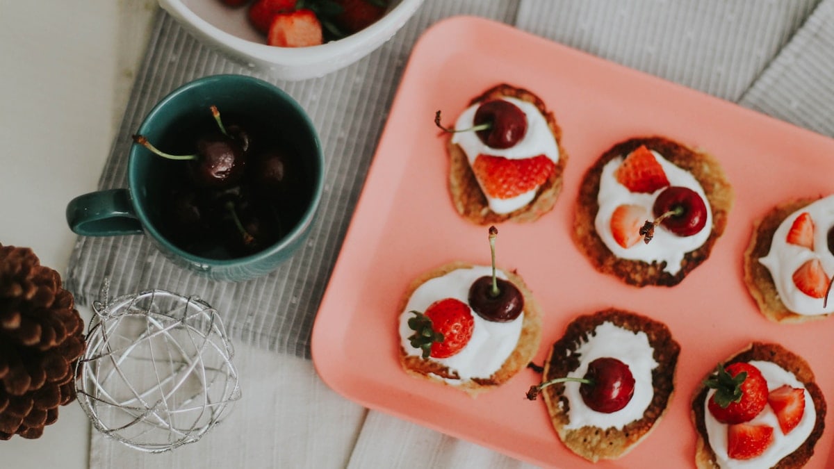 red and black fruit on white ceramic tray